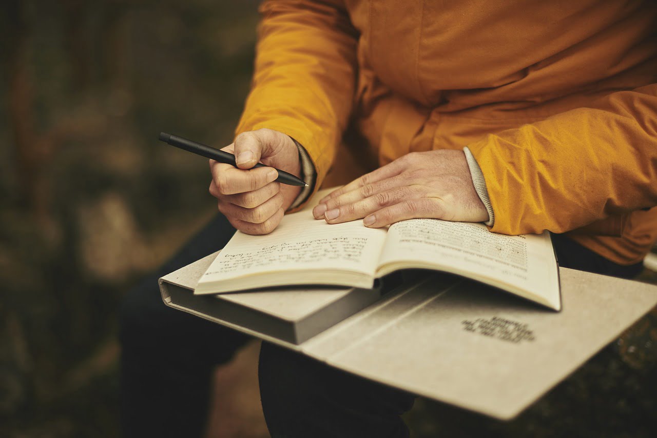 a person writing on a book