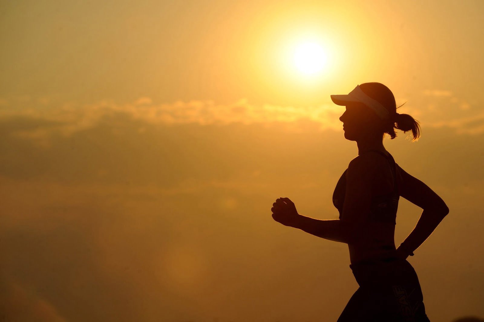 a person standing in front of a sunset