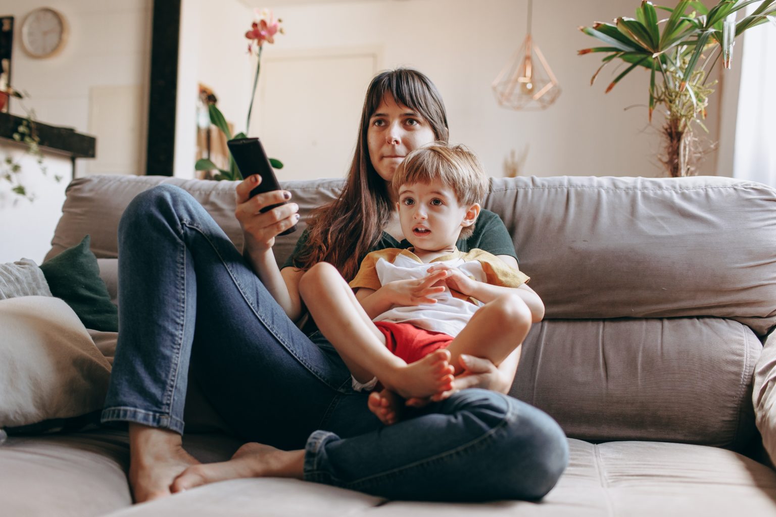 a woman and a child sitting on a couch