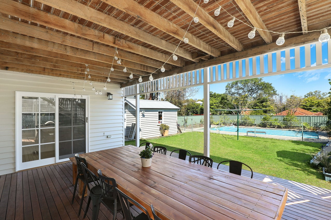 a deck with a pool and a deck with a deck and trees