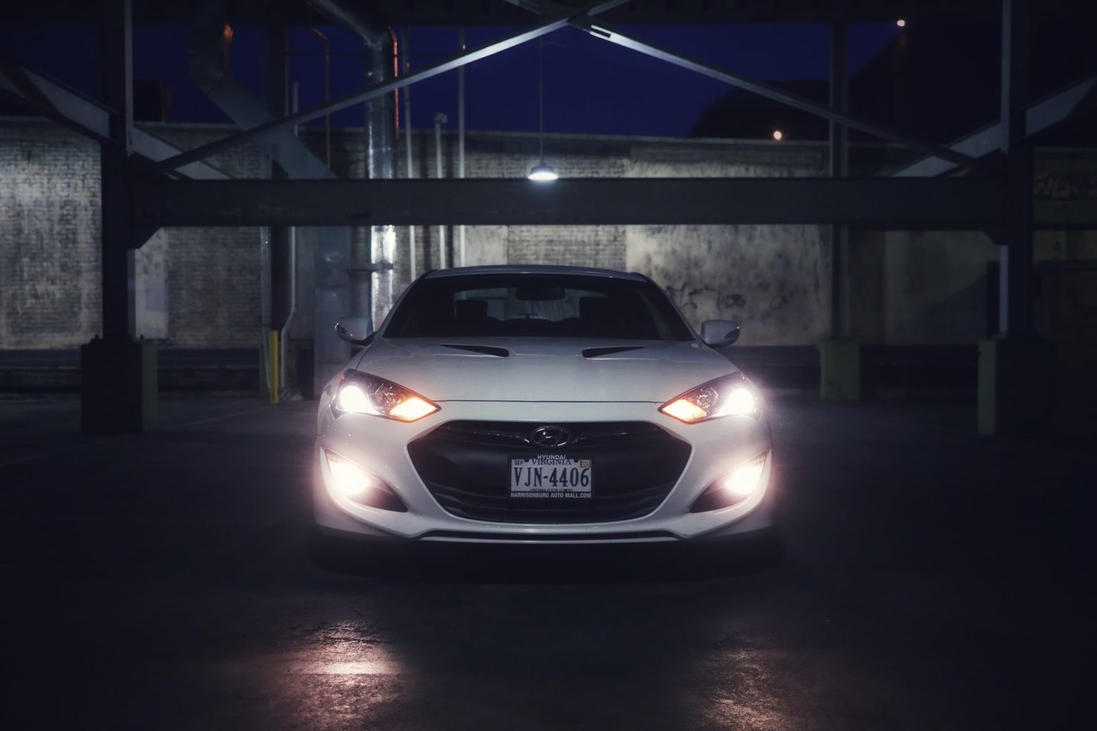 a white car parked in a parking garage