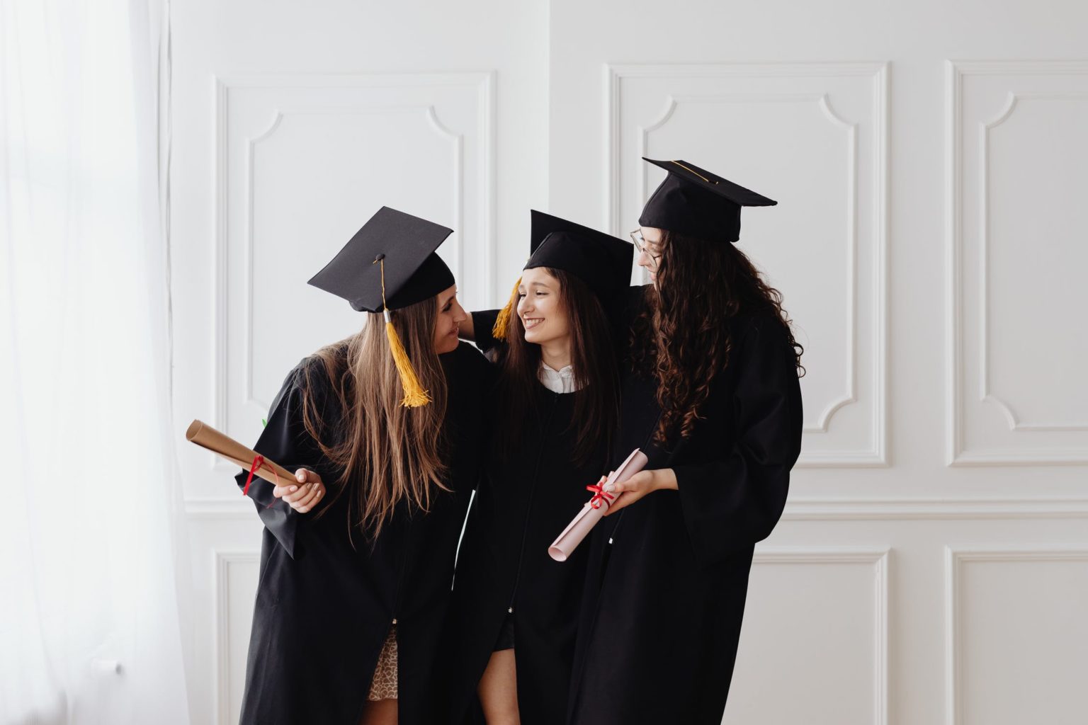 a group of women in graduation gowns and caps