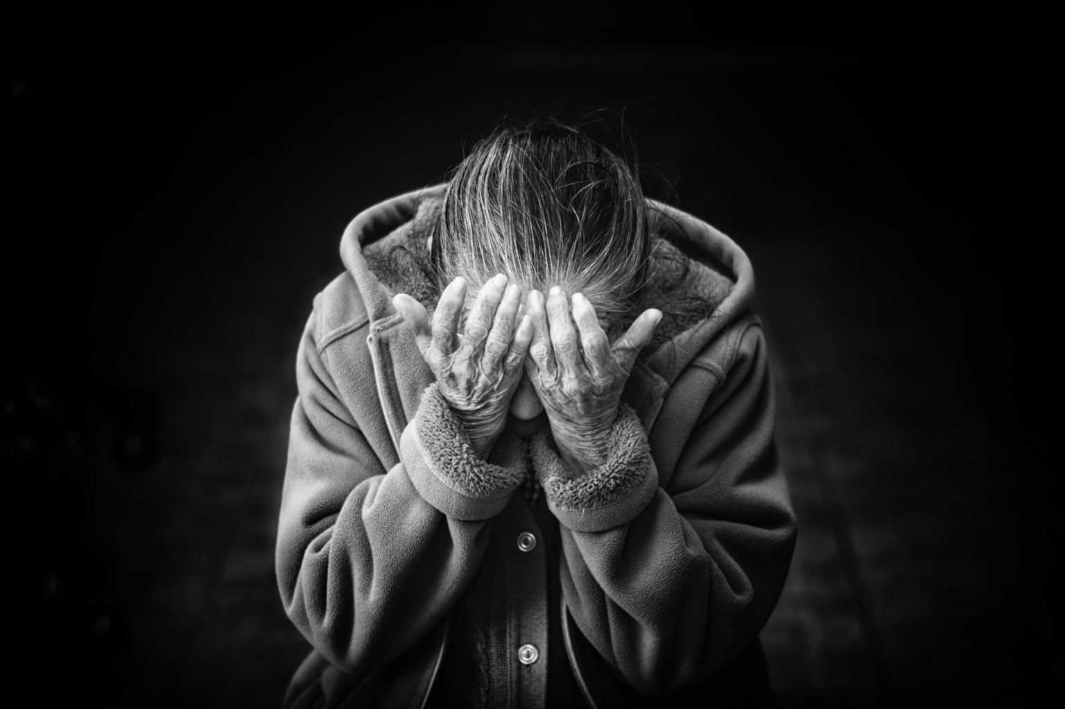 a person covering the face with the hands