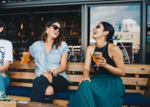 two women sitting on a bench