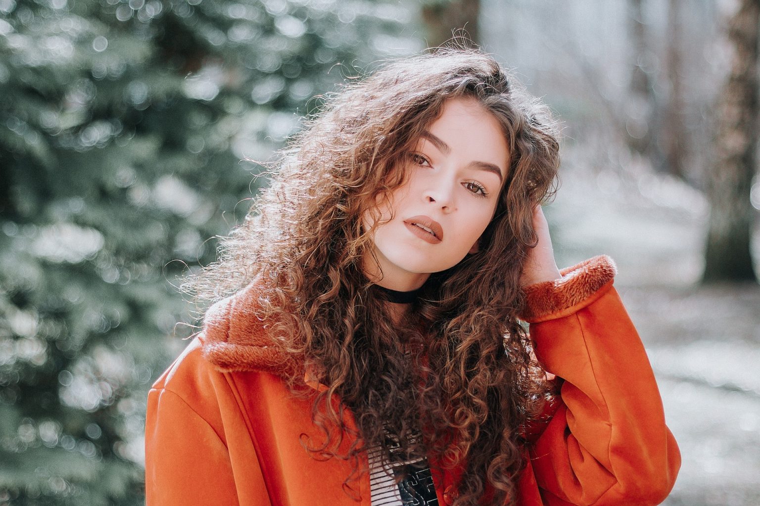 a woman in an orange jacket