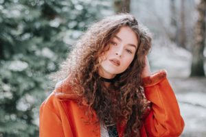 a woman in an orange jacket