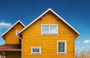 a yellow house with a blue sky