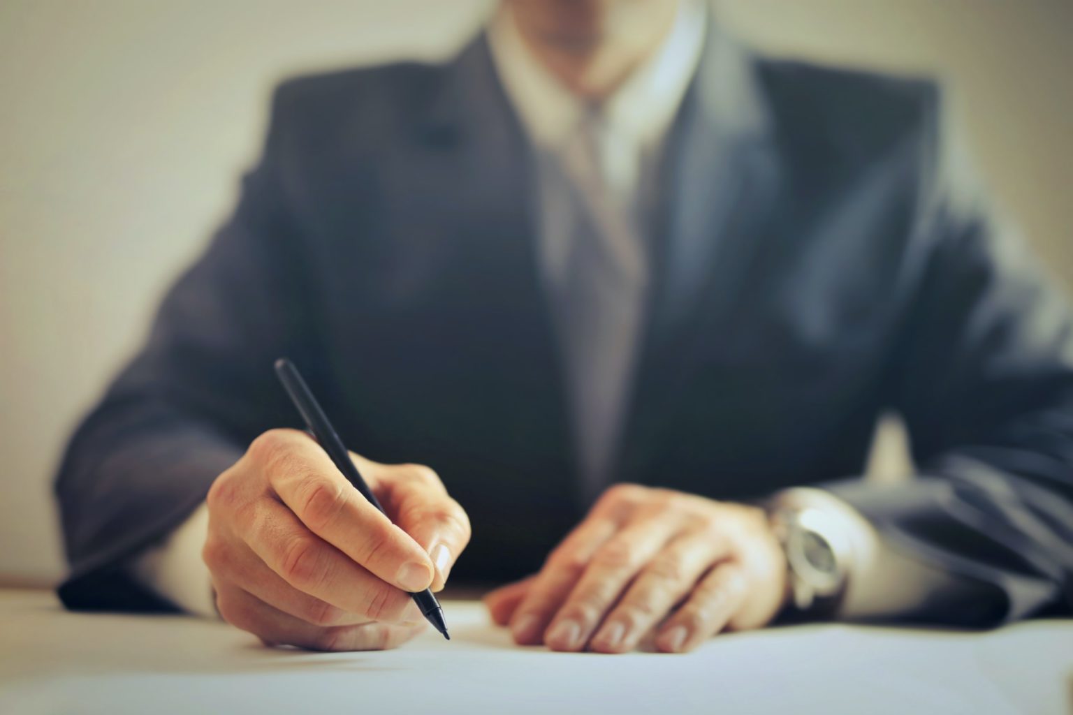 a man writing on a piece of paper