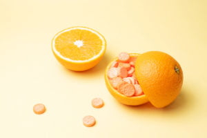 a whole orange next to a cut orange