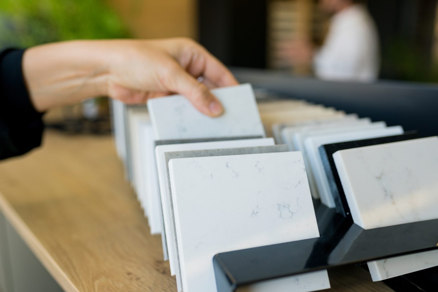 a person holding a stack of white boxes