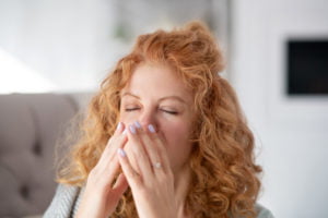 a woman with her hand on her face