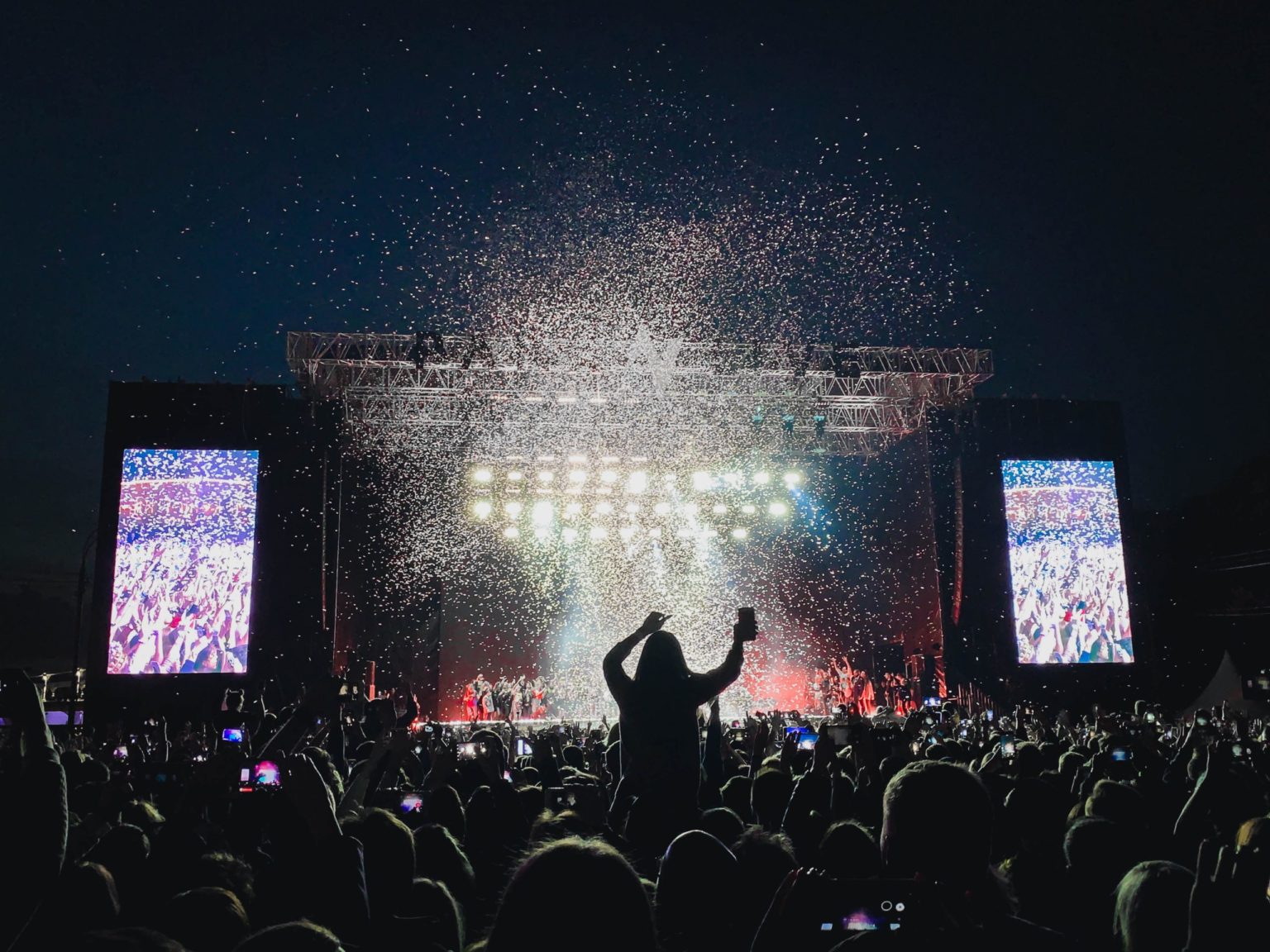a group of people on a stage with a crowd watching